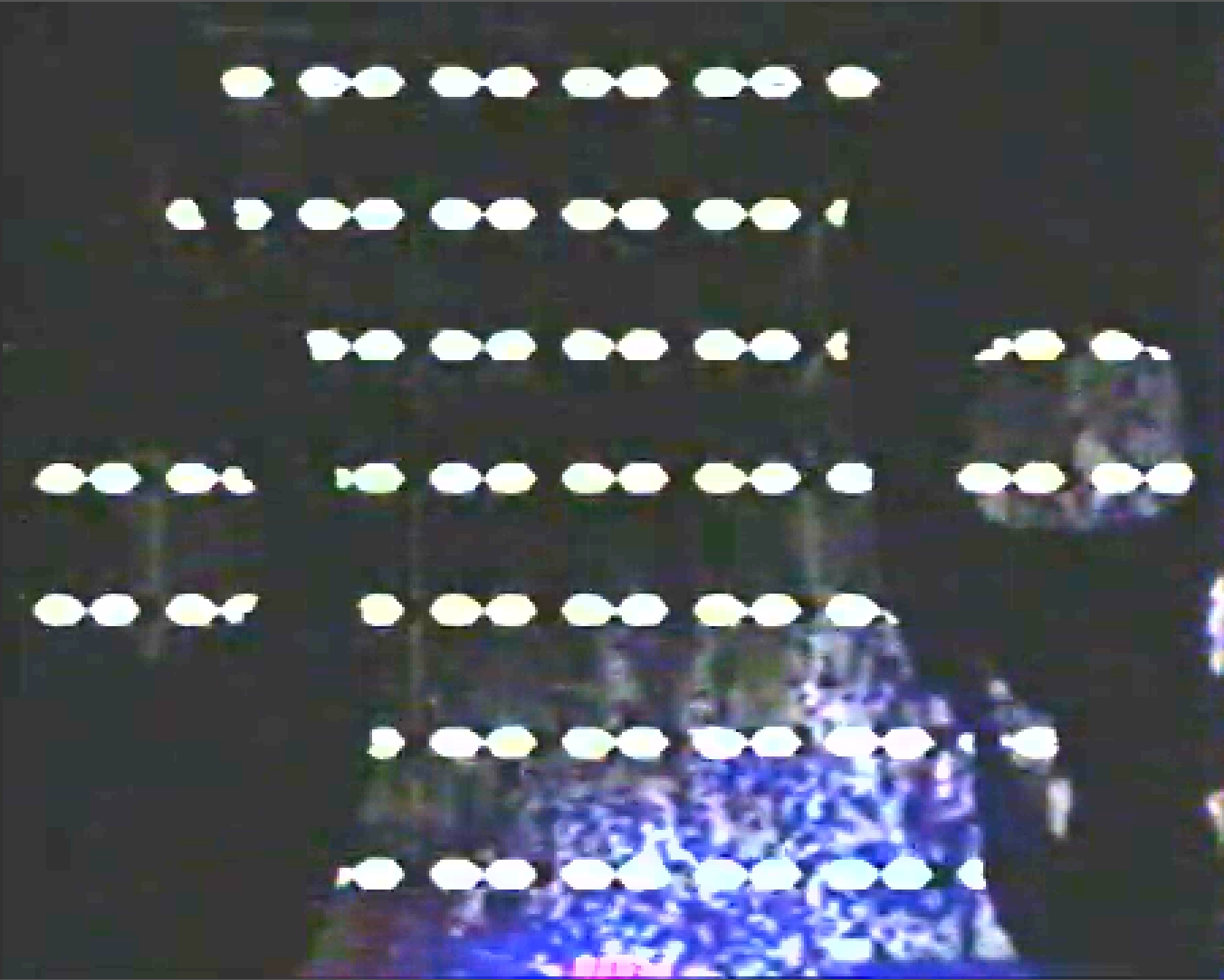 Brightened image of a wall of The Eyes with two skulls side-by-side